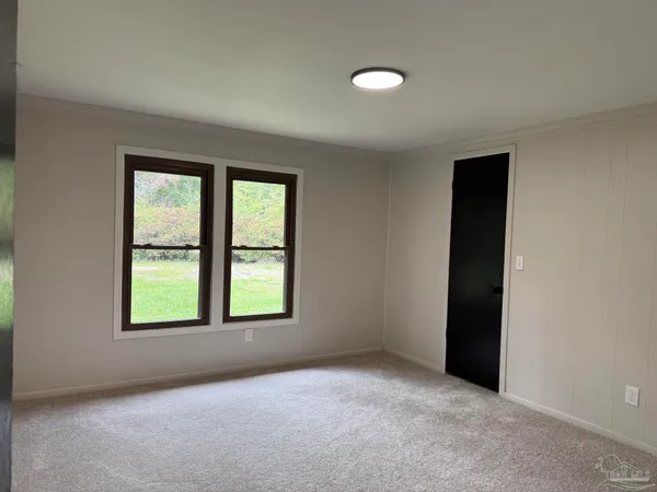 an empty room with windows and closet