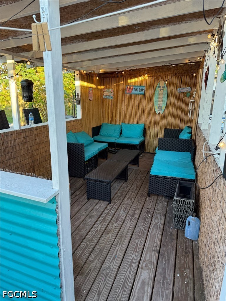6724 5th Road LaBelle, FL 33935 - Photo 19 of 28 a backyard of a house with wooden floor a barbeque oven and outdoor seating