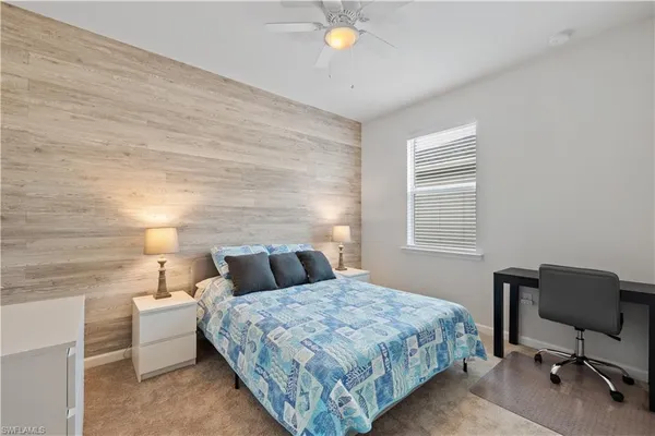 a bedroom with a bed and a chair