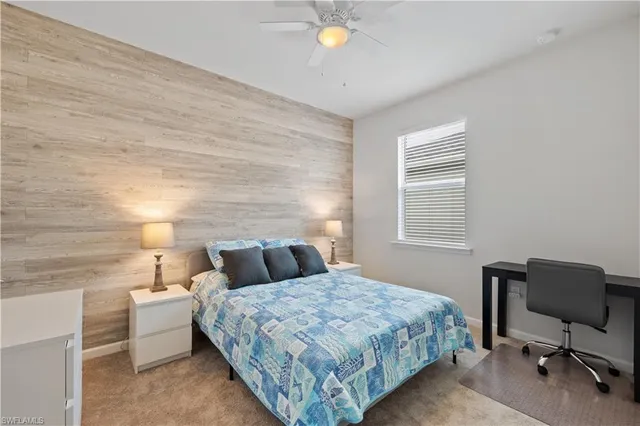 a bedroom with a bed and a chair