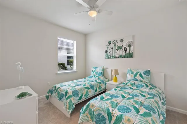 a bedroom with two beds and a chandelier