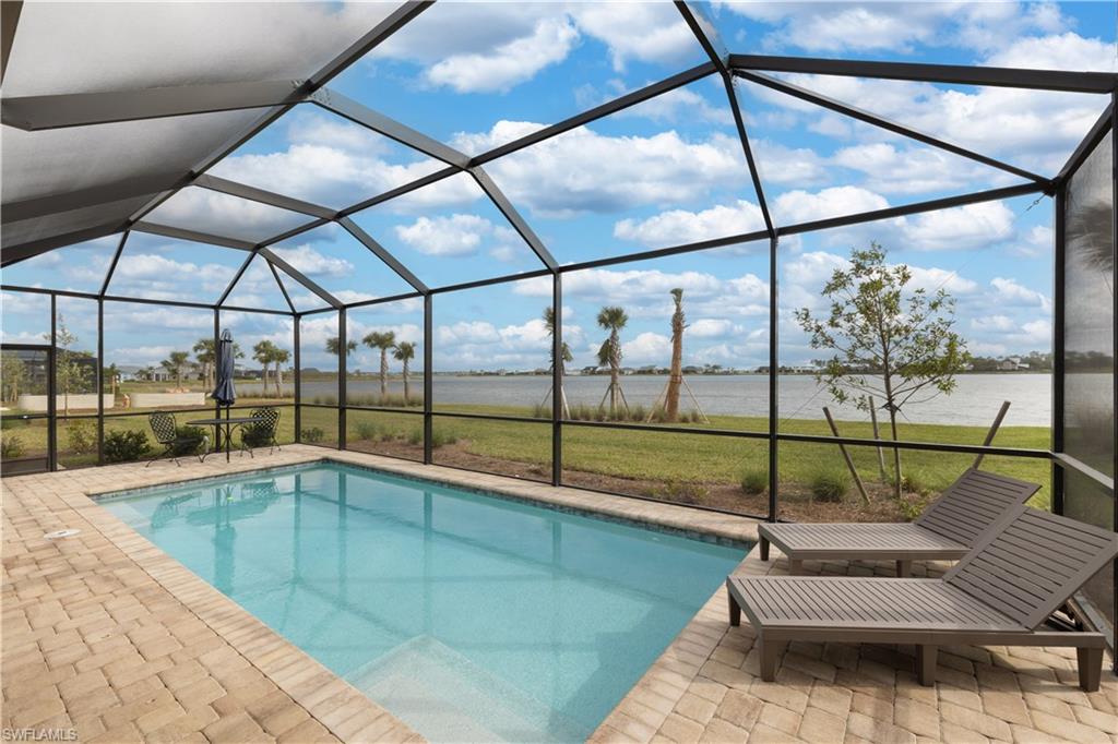 42098 Journey Drive Babcock Ranch, FL 33982 - Photo 2 of 19 a indoor swimming pool with a glass door