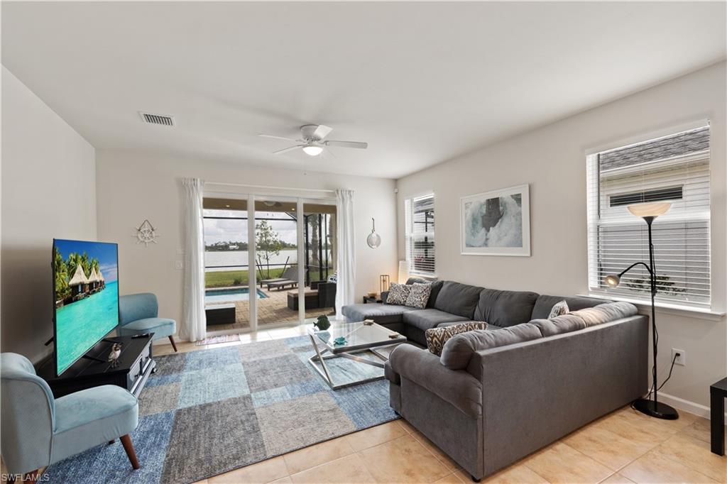 42098 Journey Drive Babcock Ranch, FL 33982 - Photo 4 of 19 a living room with furniture and a flat screen tv