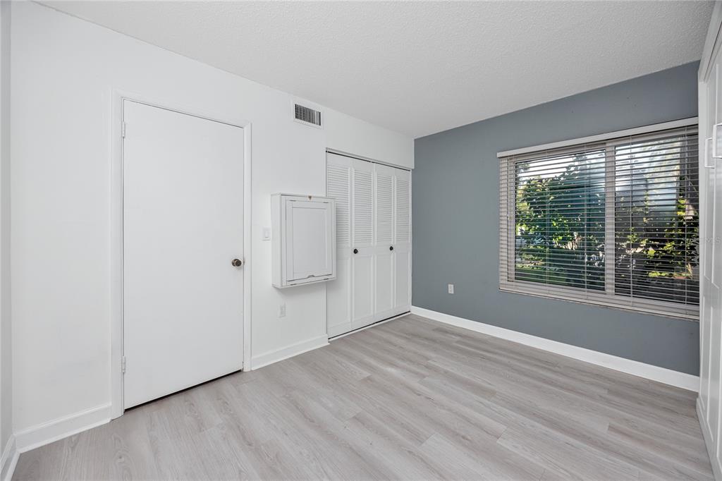 2207 Belleair Road, Unit B4 Clearwater, FL 33764 - Photo 11 of 37 a view of an empty room with wooden floor and a window