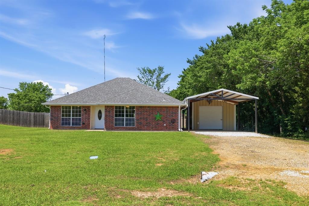 1974 County Road Powderly, TX 75473 - Photo 1 of 28 a front view of a house with a yard and trees