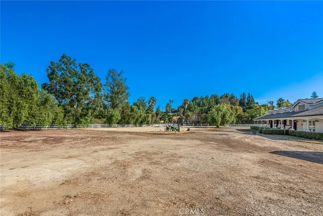 a view of a field and trees