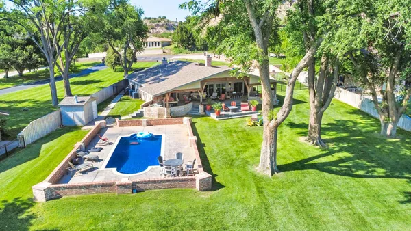 an aerial view of a house with swimming pool garden and patio