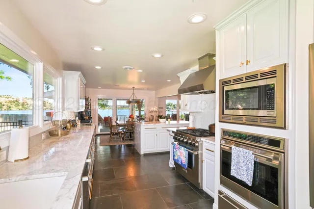 a kitchen with stainless steel appliances granite countertop a stove and a refrigerator