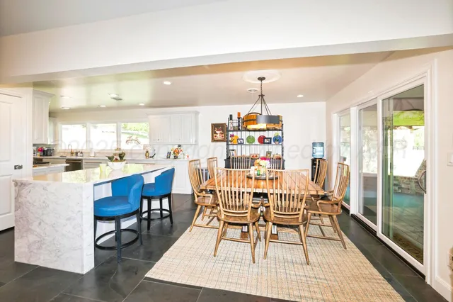 a living room with furniture a rug and a large window