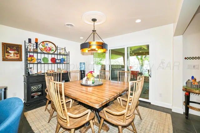 a view of a patio with dining table and chairs