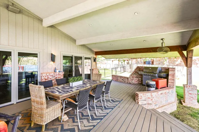 a backyard of a house with lots of green space and fountain