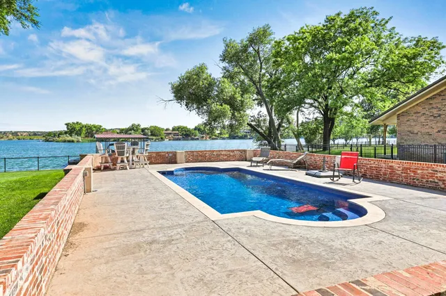 a bed room with a bed a television and a fireplace