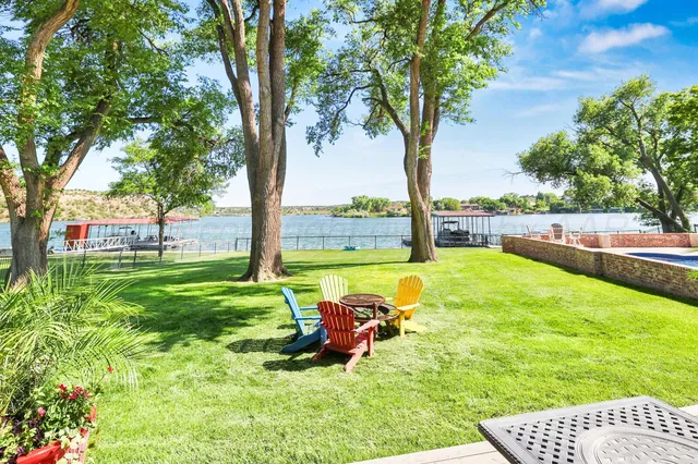 a bathroom with a granite countertop sink a toilet a mirror and bathtub