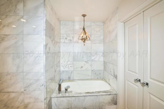 a bedroom with furniture and a large window