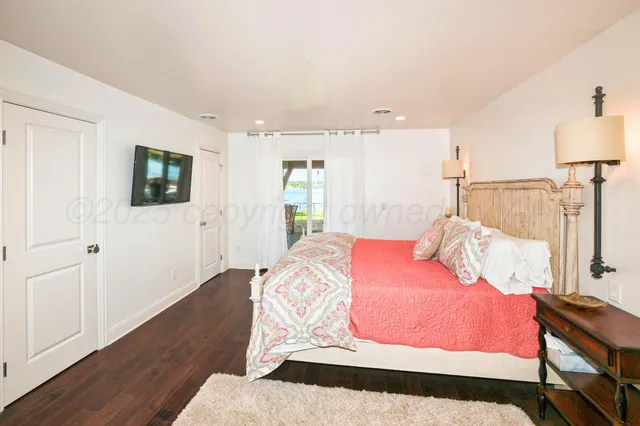 a bedroom with a bed and a flat screen tv