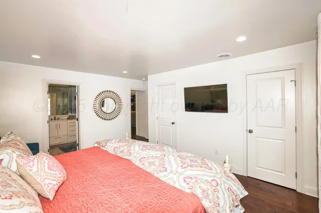 a bathroom with a sink a large mirror and a window