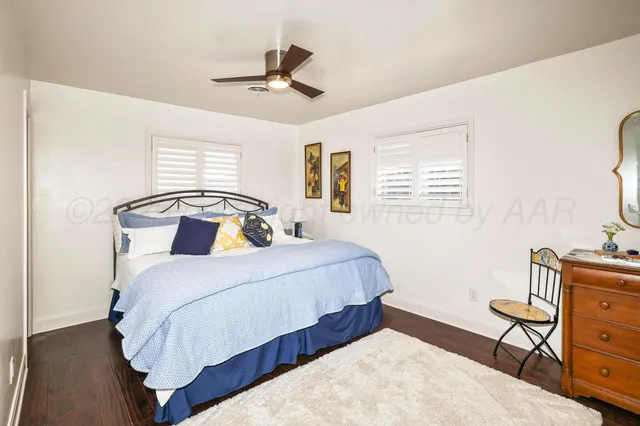 an aerial view of residential houses with outdoor space and trees all around
