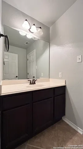 a view of an empty room with window and closet area