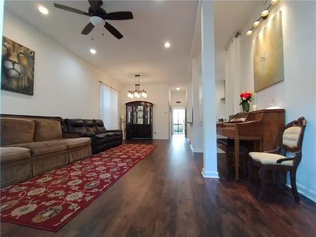 a living room with furniture and a wooden floor