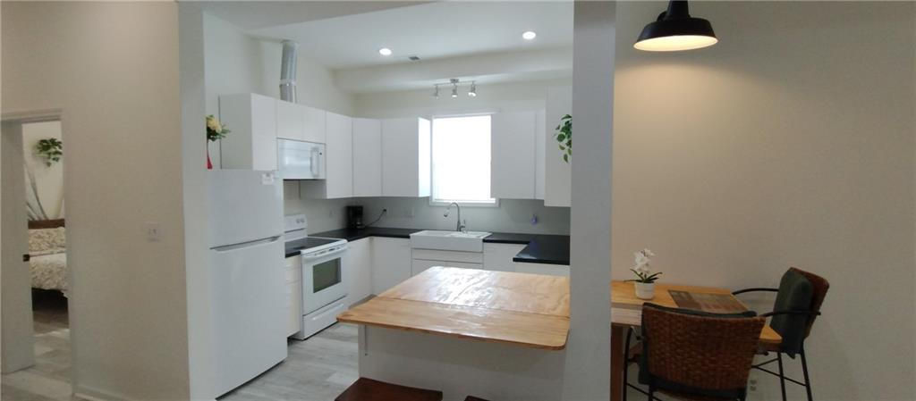 125 Strippling Street Ball Ground, GA 30107 - Photo 13 of 35 a kitchen with refrigerator and chairs