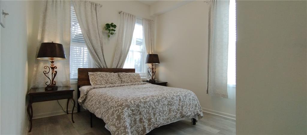 125 Strippling Street Ball Ground, GA 30107 - Photo 15 of 35 a bedroom with a bed and a mirror