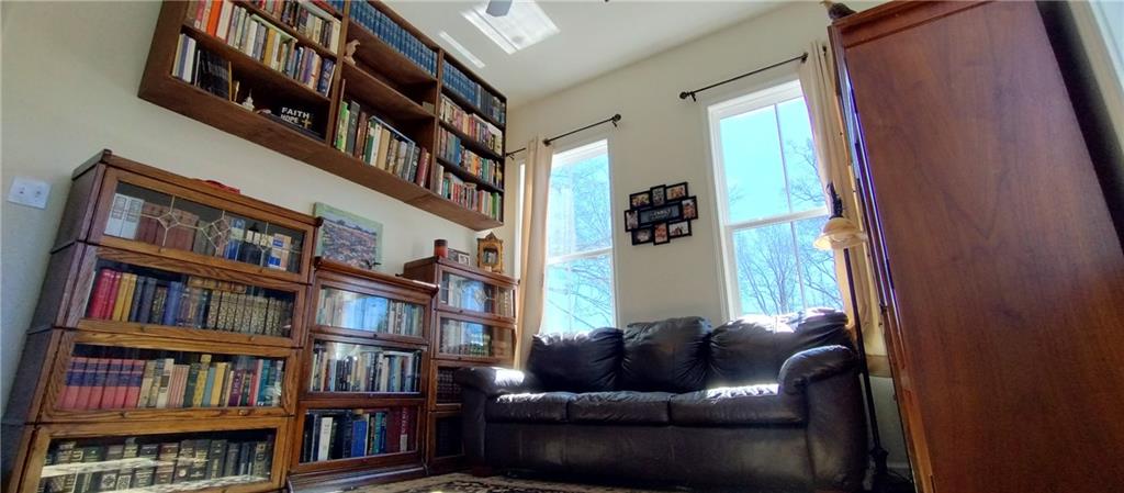 125 Strippling Street Ball Ground, GA 30107 - Photo 17 of 35 a living room with furniture and a book shelf