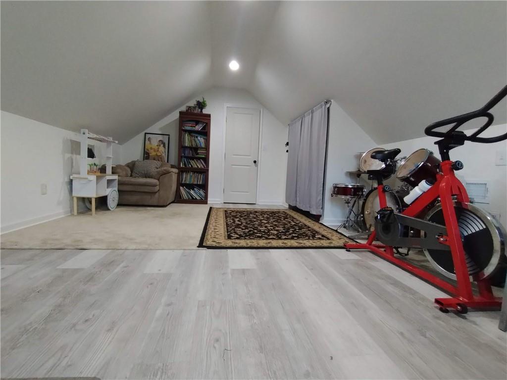 125 Strippling Street Ball Ground, GA 30107 - Photo 18 of 35 a bedroom with furniture and a gym equipment