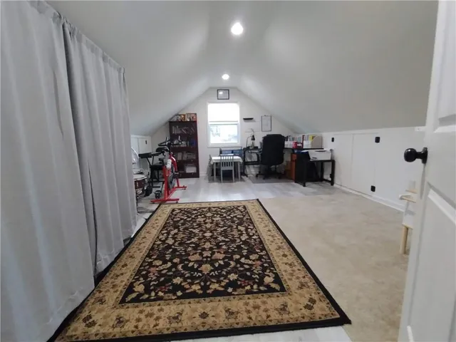 a bed sitting in a room next to a window