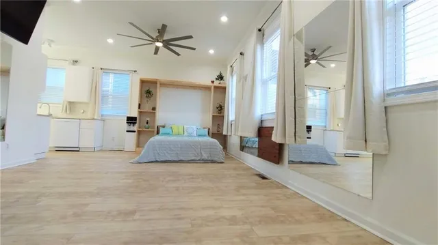 a view of a hallway with a living room and furniture