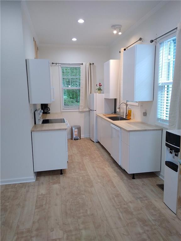 125 Strippling Street Ball Ground, GA 30107 - Photo 21 of 35 a kitchen with granite countertop a sink a window stainless steel appliances and cabinets