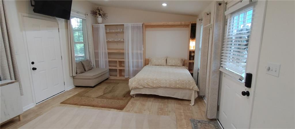 125 Strippling Street Ball Ground, GA 30107 - Photo 22 of 35 a spacious bedroom with a bed and a window