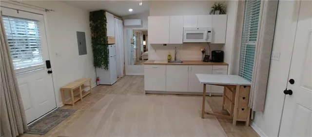 a kitchen with a refrigerator and a stove top oven
