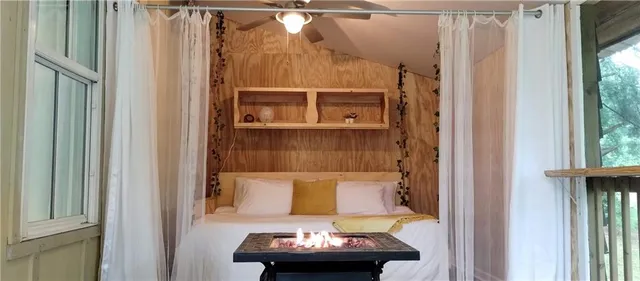 a living room with a table and a fireplace