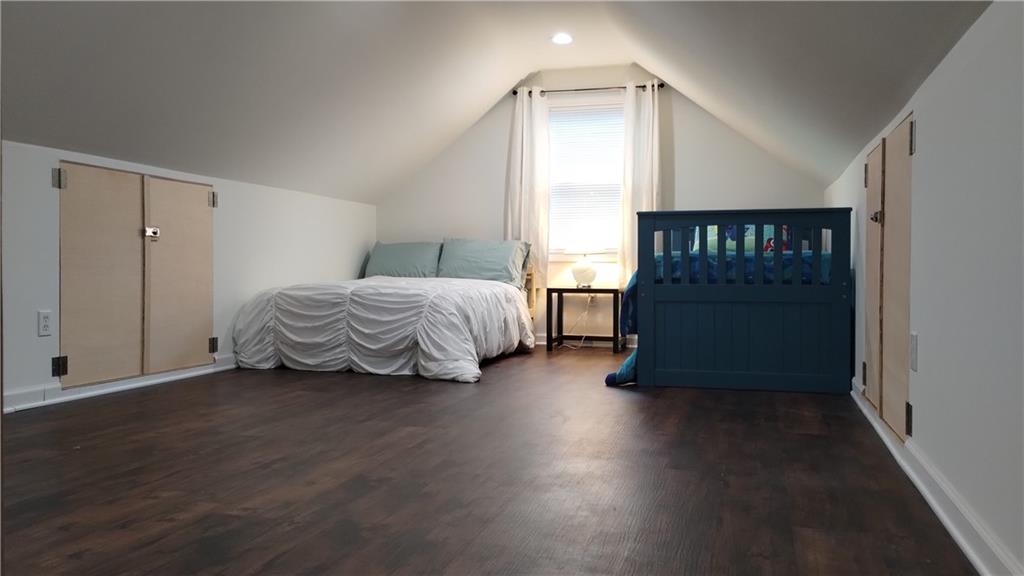 125 Strippling Street Ball Ground, GA 30107 - Photo 26 of 35 a spacious bedroom with a bed and a window