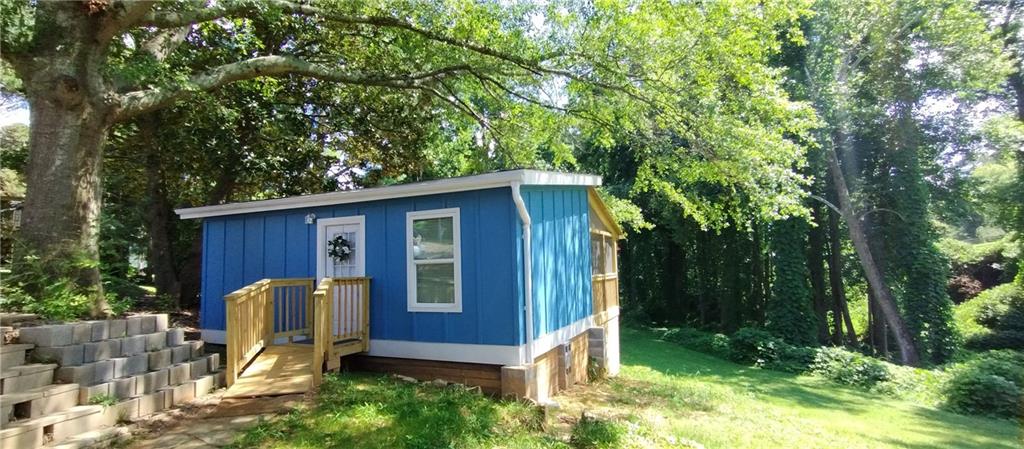 125 Strippling Street Ball Ground, GA 30107 - Photo 5 of 35 a view of backyard with a barn and large trees