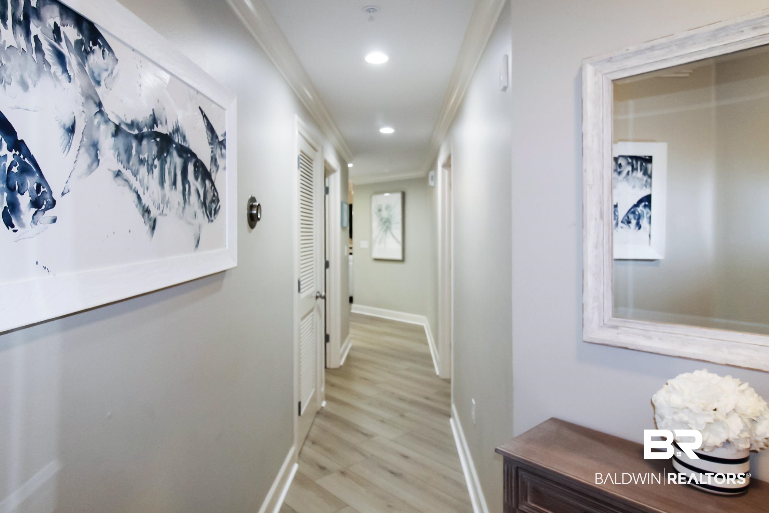 Hall featuring ornamental molding, light wood-type flooring, and recessed lighting