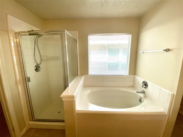 a white bath tub sitting next to a shower