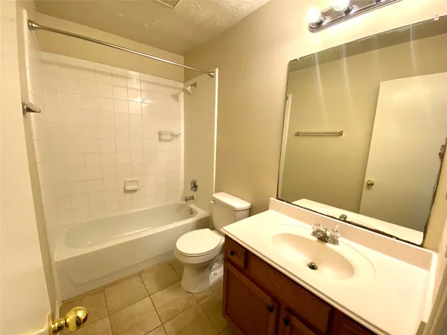 a bathroom with a sink mirror toilet and bathtub