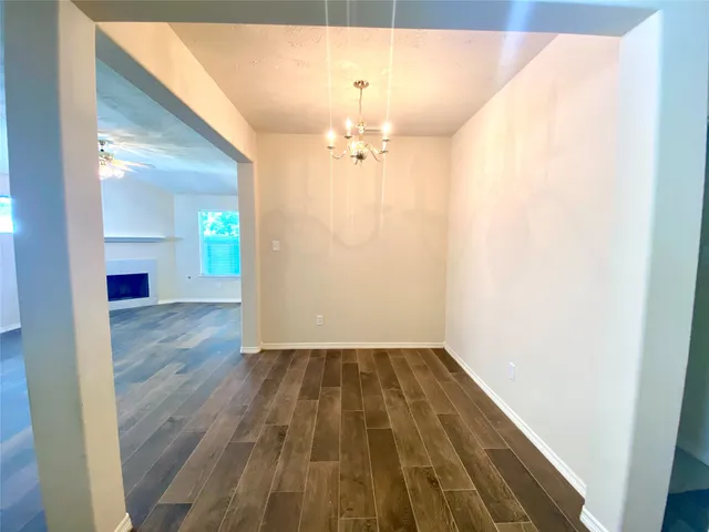 a view of a room with wooden floor closet and chandelier