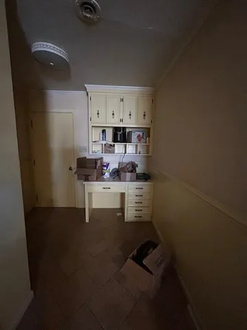 a kitchen with stainless steel appliances kitchen island granite countertop a refrigerator a stove a sink dishwasher and white cabinets with wooden floor