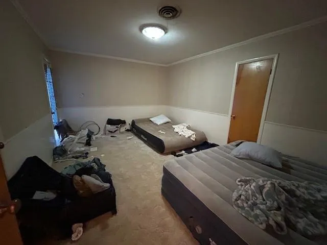 a bedroom with a bed and a mirror