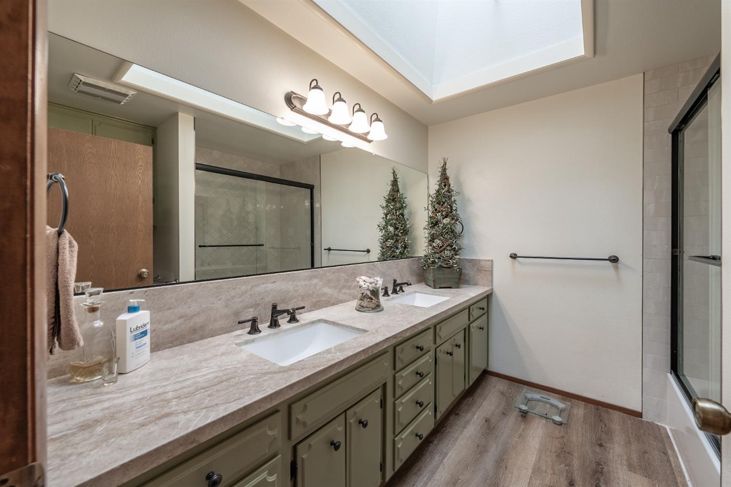 2370 Jonathan Way Madera, CA 93637 - Photo 16 of 41 a spacious bathroom with a granite countertop sink mirror and double