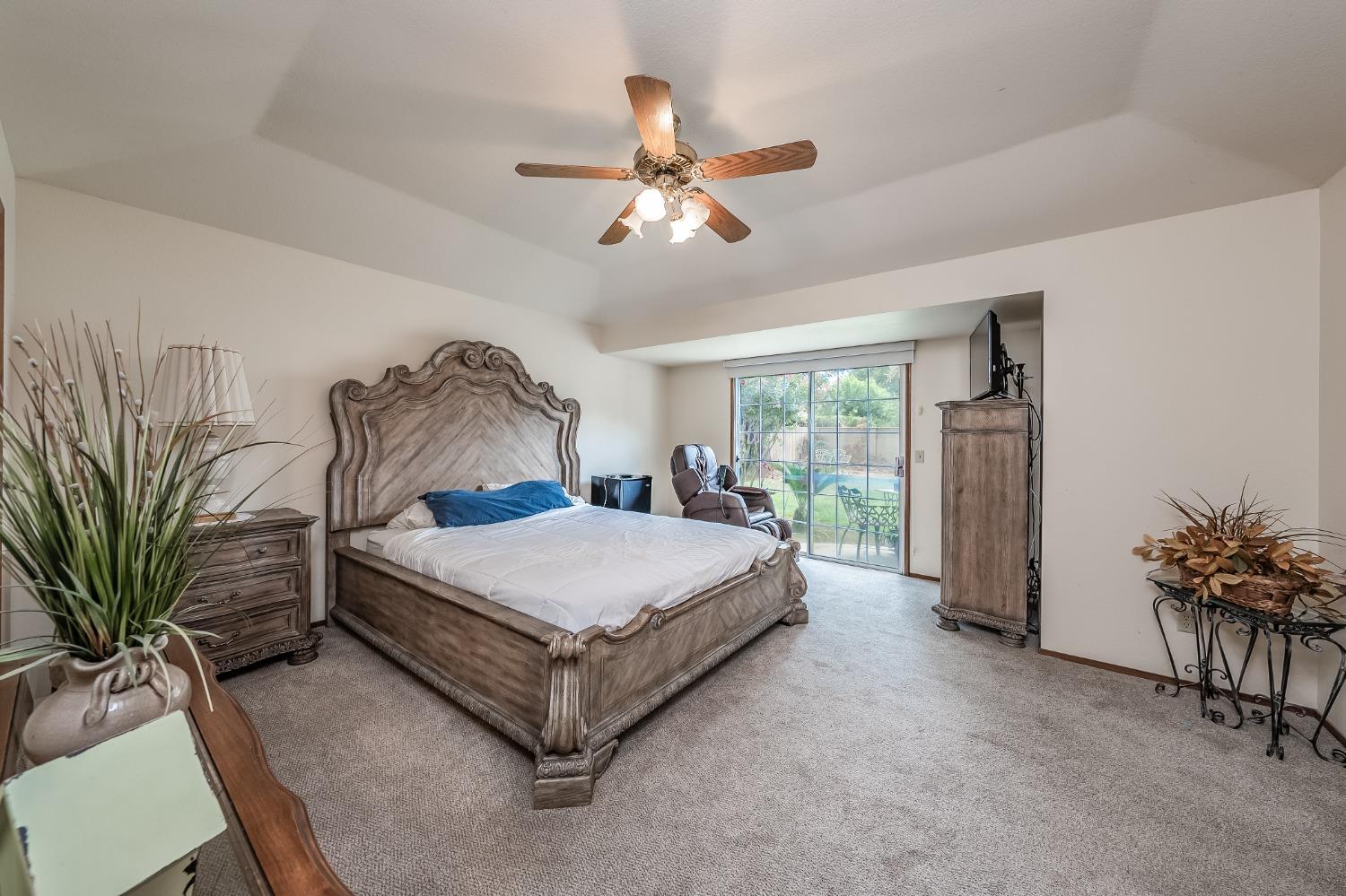 2370 Jonathan Way Madera, CA 93637 - Photo 20 of 41 a spacious bedroom with a bed table closet and a window