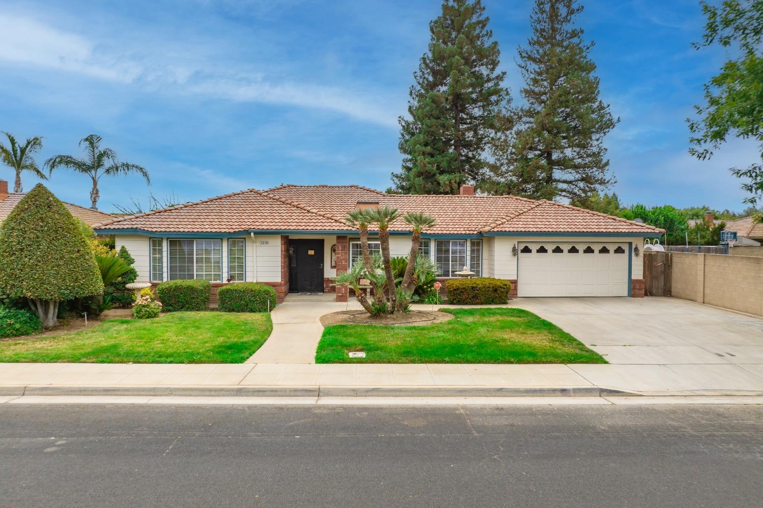 2370 Jonathan Way Madera, CA 93637 - Photo 2 of 41 a view of a white house with a big yard and potted plants