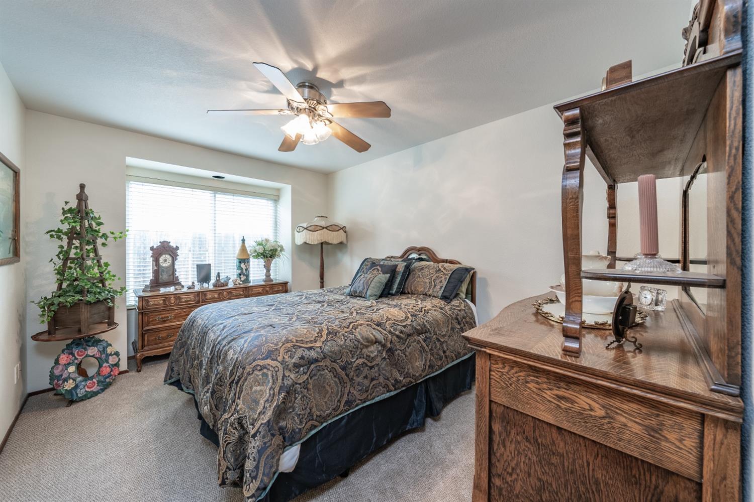 2370 Jonathan Way Madera, CA 93637 - Photo 23 of 41 a bed room with a bed and a chandelier