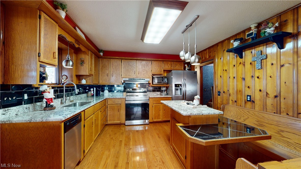 6755 State Rte 5 Ravenna, OH 44266 - Photo 10 of 34 Kitchen with light hardwood / wood-style flooring, hanging light fixtures, sink, and appliances with stainless steel finishes