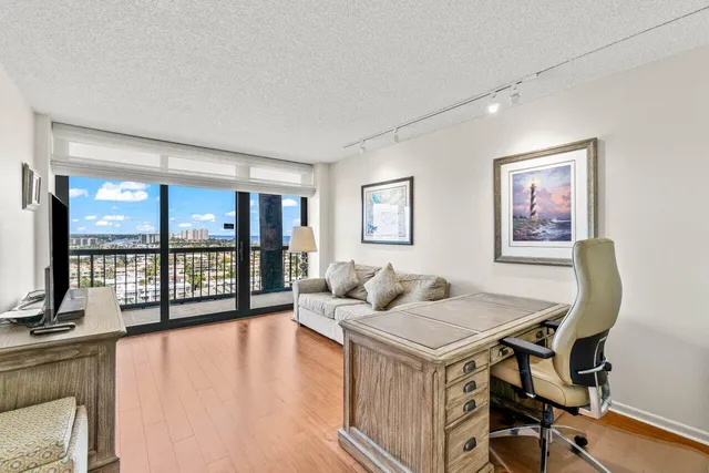 a view of a livingroom with workspace and a window