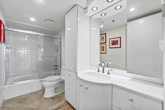 a view of a kitchen with chair and refrigerator