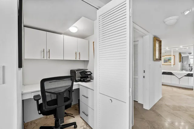 a bedroom with furniture and large windows
