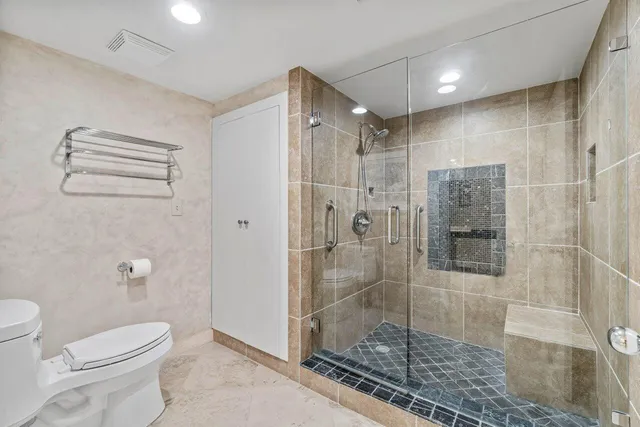 an aerial view of residential houses with outdoor space and lake view